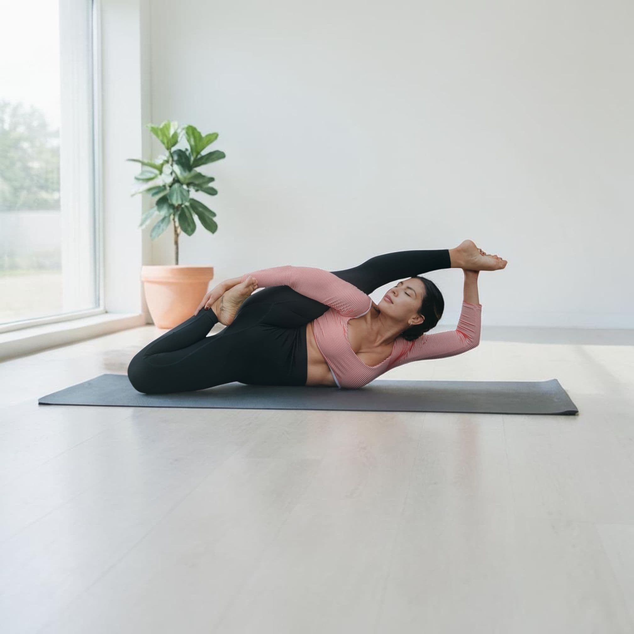 Dana practices a reclined yoga stretch on a mat.